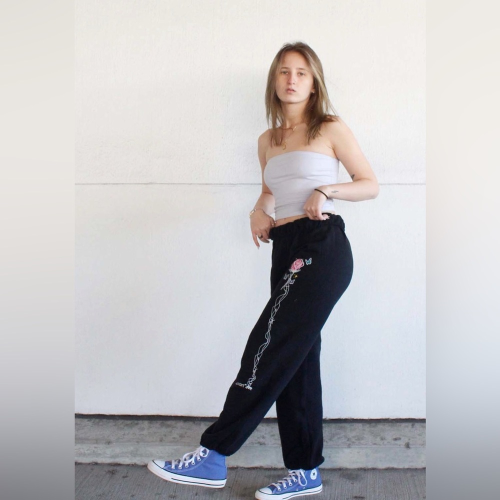 Black sweatpants with rose down the leg design